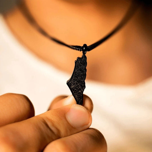 May include: A black necklace with a pendant shaped like the outline of Israel