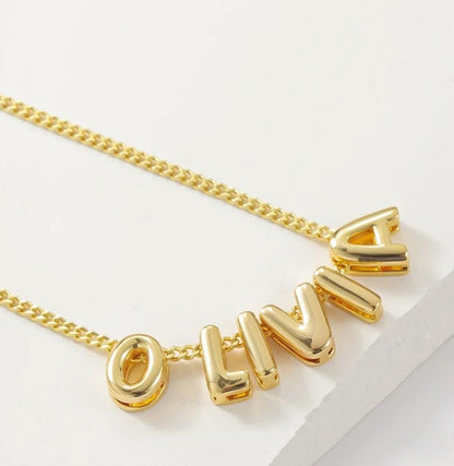 Detailed view of the bubble-letter necklace spelling ‘Olivia,’ focusing on the classic bubble style and smooth finish.