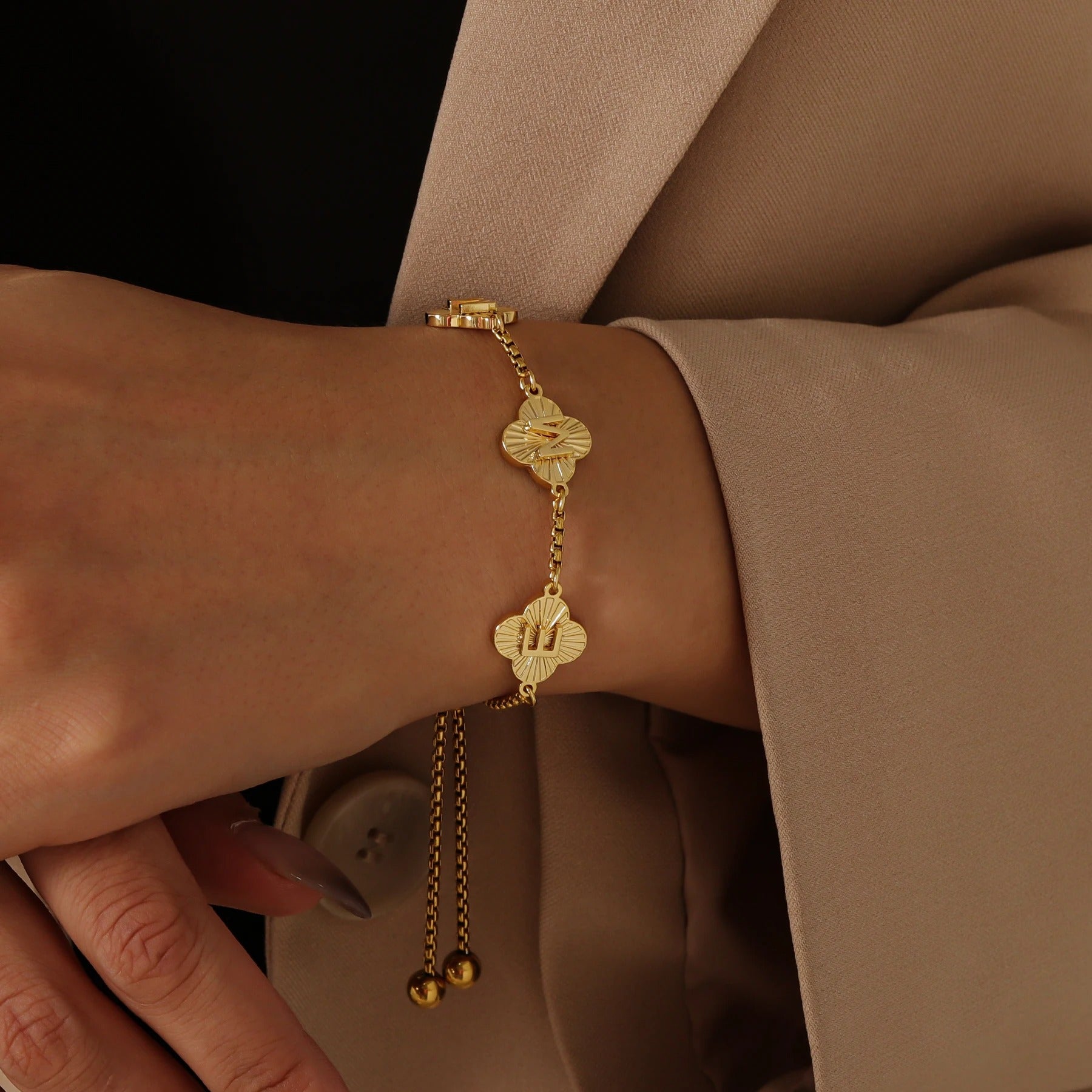 Close-up of a Signature Clover Bracelet with clover-shaped letter pendants, showcasing a delicate and elegant design perfect for personalized jewelry lovers